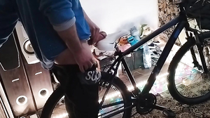 A guy massages my penis on the bike saddle until the sp