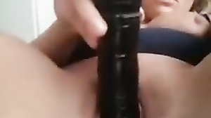 Monica inserts a dildo deep into her pussy